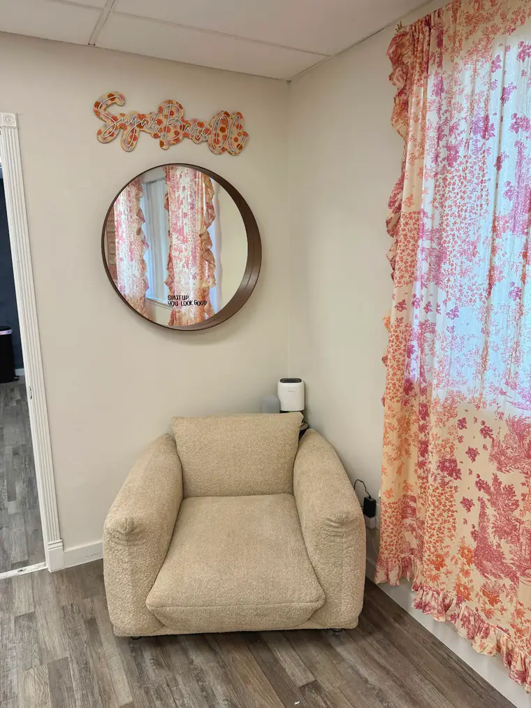 Cozy chair under a mirror that reads Shut up, you look good