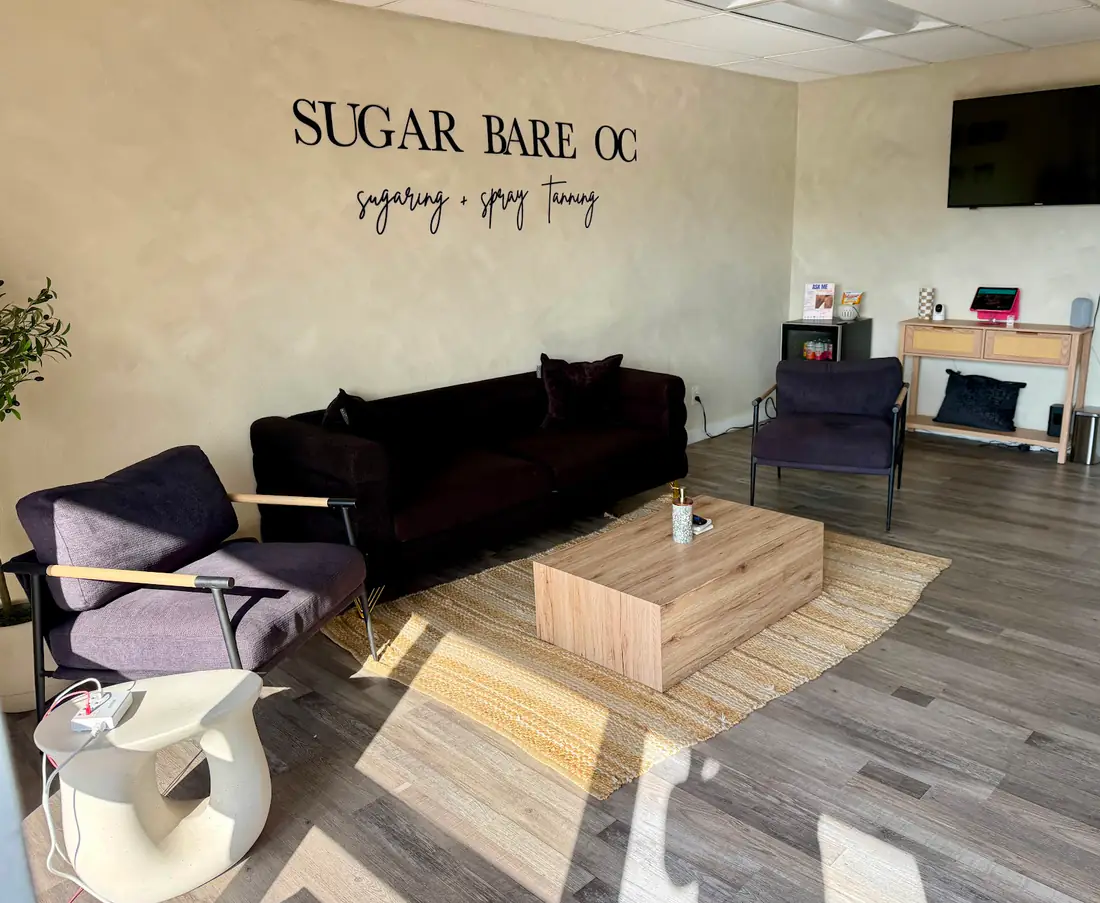 Sugar Bare OC lobby with the sugaring + spray tanning wall sign